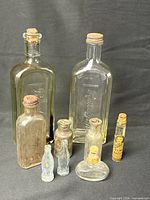 Group shot of all nine vintage glass bottles