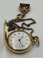 Pocket watch open with chain and fob displayed