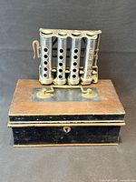 Coin changer resting on closed cash box showing overall appearance