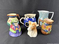 Group shot of all six English pottery pitchers