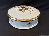 Overall view of closed round porcelain box showing lid design