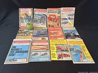 Front view of 12 magazines with apple for scale