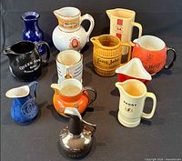 Group shot of all twelve whisky advertising jugs