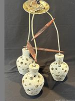 Full chandelier showing three pottery shades, teak brackets, brass canopy