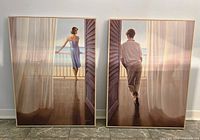 Both framed prints standing side by side against wall