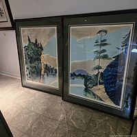 Both framed prints side by side on floor showing overall condition