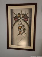 Full frontal view of framed print hanging on wall