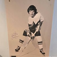 Full view of signed Paul Henderson poster showing player stance and overall wear