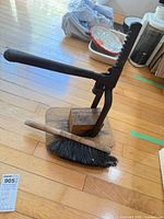 Full view bottle capper on wooden base with hand broom