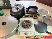 Group shot of hot plate, stock pot, roaster, bakeware and cookware