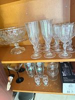 Overall view showing compote stand, multiple stemware, pint glasses, martini glasses, cordial glasses and boxed shaker set