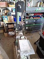 Full view of Viking vertical bandsaw, manual visible on table