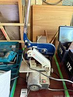 Overall view showing both the blue metal shear and the cream Bexon belt sander