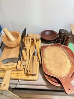 Overall lot with boards, utensils, mortar & pestle, ulu, pepper mills