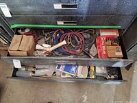 Drawer with cables, boxes of nails/staples, abrasive wheel, sandpaper and engraver