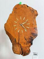 Front view showing overall clock shape, wood grain and face