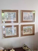 All four framed prints hung on wall