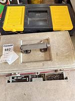 Two closed toolboxes, Plano black/yellow and beige, overall lot view