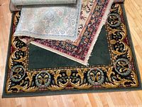Stacked rugs showing border patterns and colors