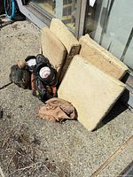 Lot overview showing three catcher pads, gloves, baseballs, cleats