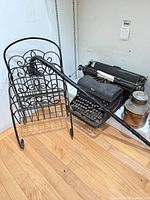 Group shot of typewriter, magazine rack, milk can