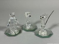Group shot of three Swarovski crystal animal figurines on mirrored bases