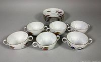 Six soup bowls with six saucers stacked behind