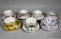 All seven teacup and saucer sets displayed