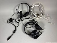 Three pairs of headphones with cables displayed