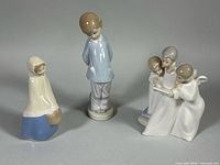 Front view of all three porcelain figurines