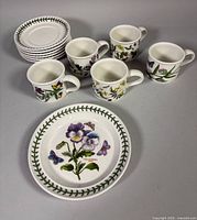 Full set: five cups, six saucers stacked, one decorated plate