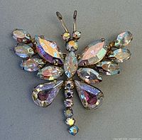 Front view of dragonfly brooch displaying multicolour rhinestones