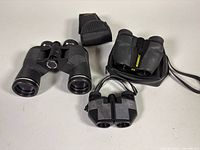 All three binoculars with two soft cases displayed