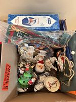 Open box showing Breyer box, snowman ornaments, plates, tree ornament, gift bag
