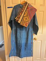 Full view of blue dress with shawl draped over shoulder