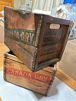 Two stacked Canada Dry wooden crates showing overall form and logos