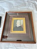 Front view showing portrait, frame, cracked glass