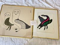 Front view of both framed bird artworks