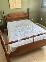Full view of assembled bed frame with mattress and pad