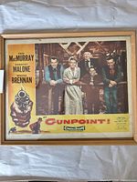 Front view of framed lobby card showing full artwork and frame condition