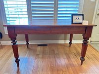 Full view of rectangular wooden table against window