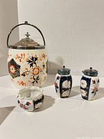 Group shot of biscuit jar, two shakers and sugar dish