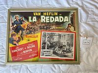 Front view of framed Spanish movie poster and attached film still