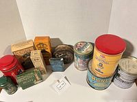 Overall group shot showing all 13 tins and boxes
