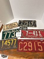 All seven license plates laid out showing fronts