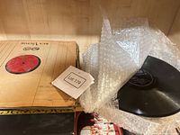 Stack of RCA Victor sleeved 78 RPM records, bubble-wrapped loose record