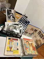 Overview of briefcase with prints, binder, scrapbook, negatives