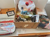 Overview of lot showing box of wool strips, book, kit and framed card