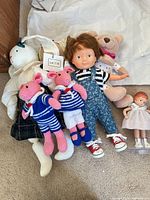 Group shot showing all dolls and plush on carpet