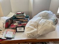 Overall lot showing batting bag, fabric stacks, pattern sheets